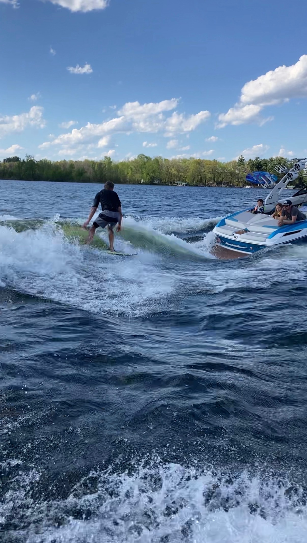 Rider wakesurfing beside the Malibu