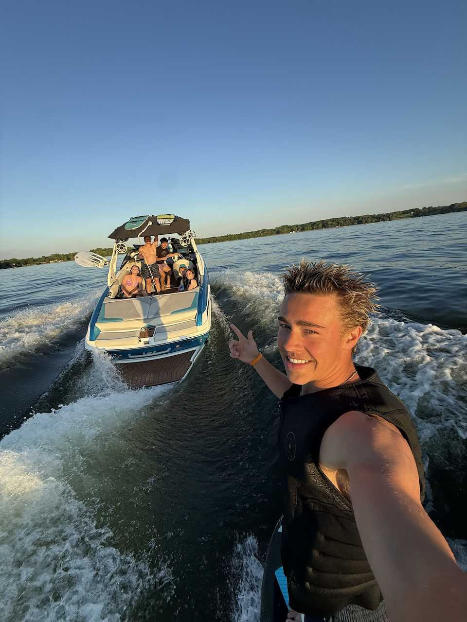 Your coach wakesurfing behind the boat