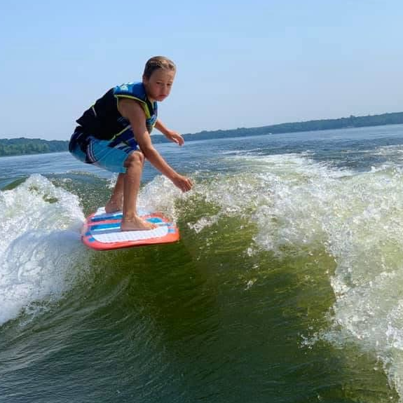 Young rider surfing the wake